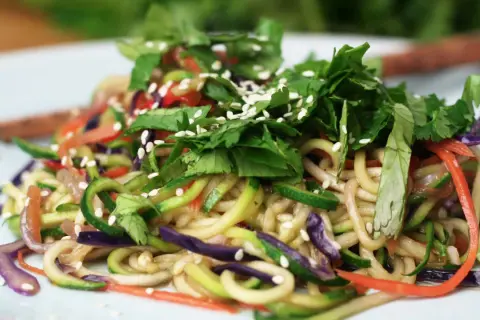 Makaron chow mein z warzywami: cukinią, marchewką, czerwoną kapustą i sezamem.
